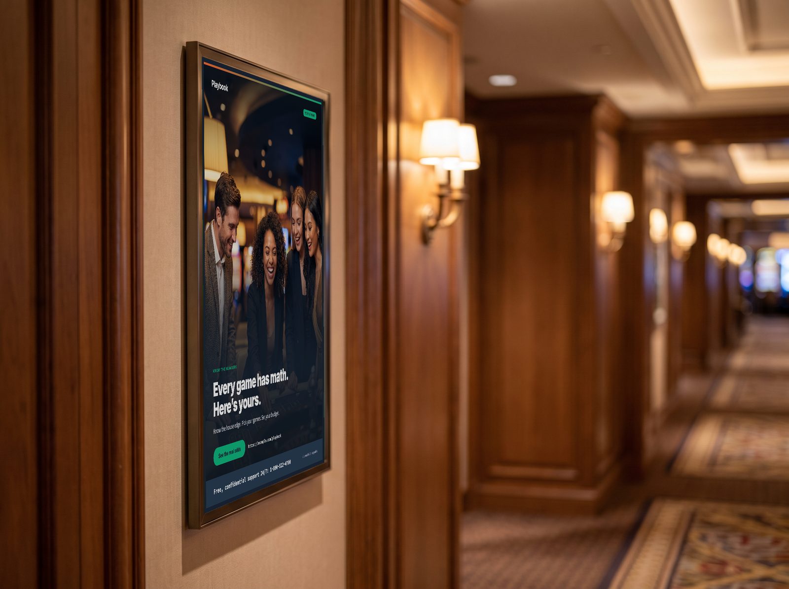 The framed Playbook poster in a casino corridor: friends laughing at a table under the headline “Every game has math. Here’s yours.”