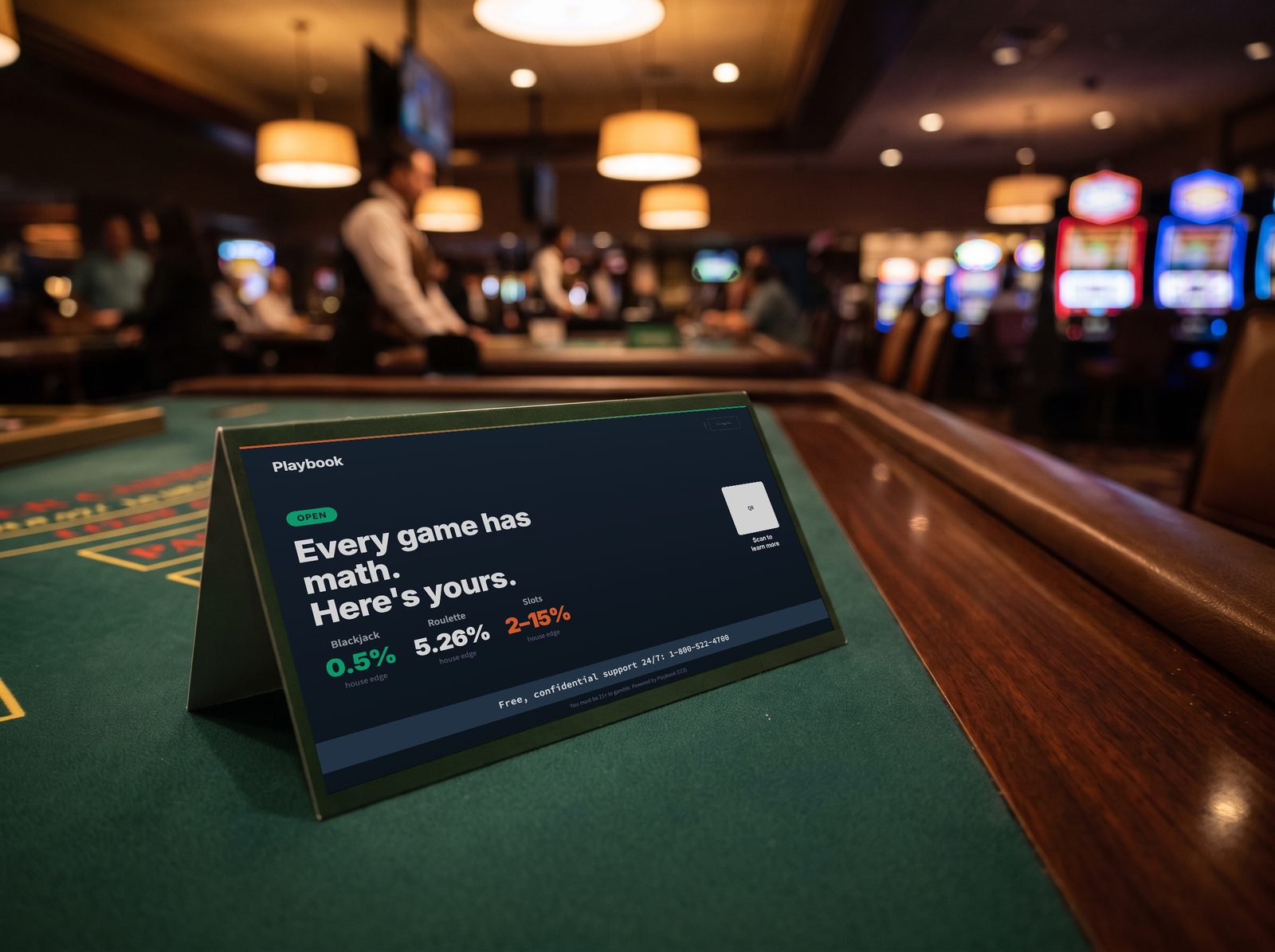 The Playbook table tent on casino felt, reading “Every game has math. Here’s yours.” with the house edge for blackjack, roulette, and slots.